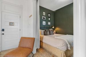 a bedroom with a bed and a chair at Downtown Palace Hotel Suite - Steps to Adventure in Salida +14 photos