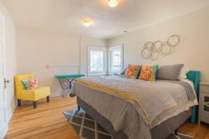 a bedroom with a bed and a olympics sign on the wall at Sleeps 10 Walkable to Everything Pets Game Room in Salida