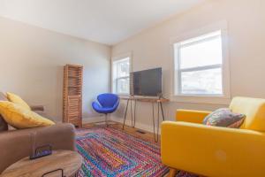 a living room with a yellow couch and a tv at Sleeps 10 Walkable to Everything Pets Game Room in Salida +26 photos