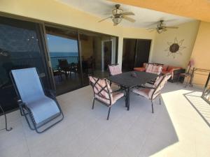 a patio with a table and chairs on a balcony at Sonoran Sea 2 Bedroom 2 Bath 7th Floor in Puerto Peñasco
