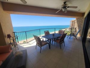 a balcony with a table and chairs and the ocean at Sonoran Sea 2 Bedroom 2 Bath 7th Floor in Puerto Peñasco