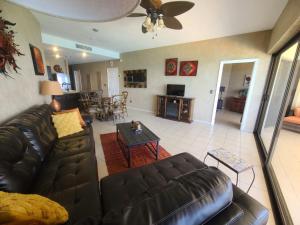 a living room with a leather couch and a table at Sonoran Sea 2 Bedroom 2 Bath 7th Floor in Puerto Peñasco +18 photos