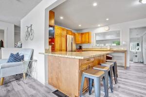 a kitchen with a counter and a bar with stools at 4BR Downtown Basecamp - Walk to Everything in Salida