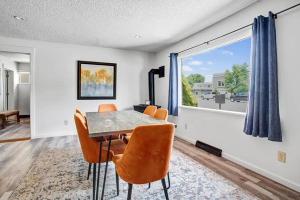 a dining room with a table and chairs and a window at 4BR Downtown Basecamp - Walk to Everything in Salida