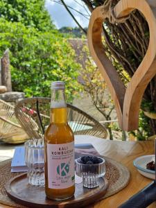 a bottle of beer sitting on top of a table at Origines Be Holistic in Brengues