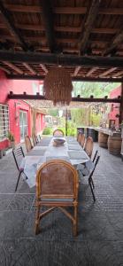a dining room table with chairs and a chandelier at Lodi House in Godoy Cruz