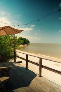 a table and an umbrella on the beach at Vilarejo in Belém
