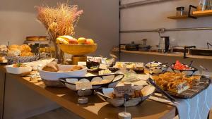 a table with many different types of food on it at Pousada Refugio da Ilha Ilhabela in Ilhabela