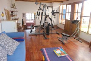 a living room with two exercise bikes and a blue couch at La Selenita in Sucre