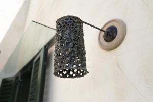 a speaker hanging on the side of a wall at Biccari 6 Terrace Apartament in Lecce +50 photos