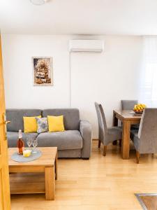 a living room with a couch and a table at Викендица Братунац in Bratunac