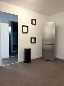 a refrigerator in a room with a trash can at Le clos du landreau in Saint-Père-en-Retz