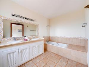 a bathroom with two sinks and a tub and a mirror at Villa in El Agar with Private Pool and Beaches in Mina Blanca