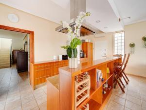 a kitchen with a counter with a vase of flowers at Villa in El Agar with Private Pool and Beaches in Mina Blanca