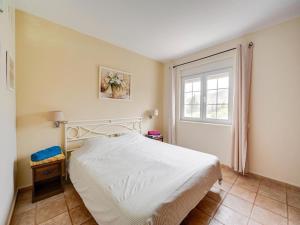 a bedroom with a white bed and a window at Villa in El Agar with Private Pool and Beaches in Mina Blanca