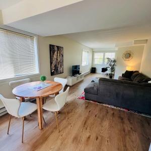 a living room with a table and a couch at The Wineries are Calling! in Penticton