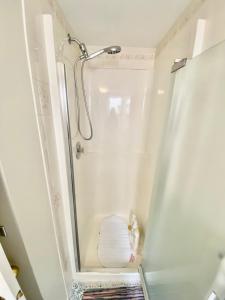 a bathroom with a shower with a white shower curtain at The Wineries are Calling! in Penticton +13 photos