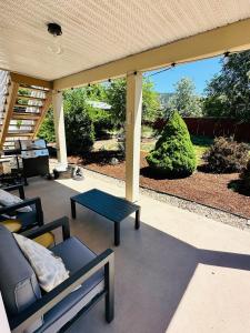 a covered patio with a couch and a table at The Wineries are Calling! in Penticton