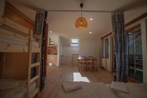 a bedroom with two bunk beds and a dining room at Apartmány Kořenný in Korěnný