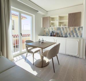 a kitchen with a table and chairs and a window at Ivory Dimora di Charme in Terracina