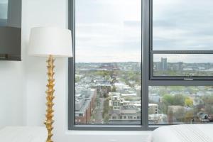 a room with a window with a view of a city at Central Upscale 2BR Condo wGym Office & Parking in Cambridge