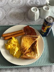 a plate of breakfast food with eggs bacon and toast at The Gardens view lodge in Bushbuckridge