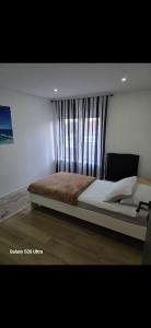 a bedroom with a large bed with a window at Fleurus House in Fleurus