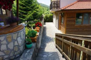 a walkway next to a house with flowers on it at Mini Complex Rilski Terasi in Sapareva Banya