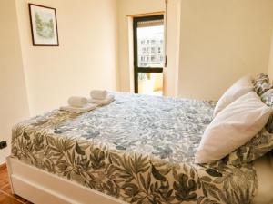 a bedroom with a bed with towels on it at SwordFish Beach Escape Apartment in Atouguia da Baleia