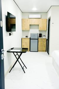 a small kitchen with a table in a room at SkyGate Hotel in Pʼarakʼar