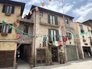 a group of buildings with flags hanging from them at Luna Toscana in Santeagueda