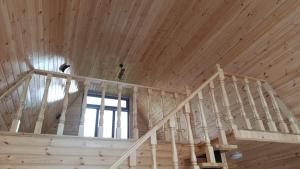 a wooden staircase in a home with a wooden ceiling at Kungut A-Frame Deluxe in Sheki