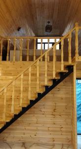a staircase in a cabin with wood floors at Kungut A-Frame Deluxe in Sheki