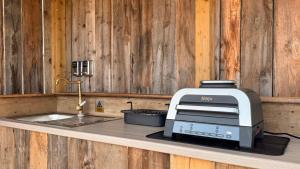 a toaster sitting on a counter next to a sink at Star Gazing Dome 1 with cozy log burner in Horspath