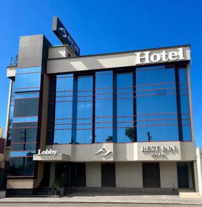 a hotel with a sign on top of a building at Rest Inn Baja in Ensenada