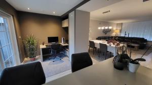 a living room and dining room with a table and chairs at Tomorowland Woning in Boom in Boom