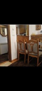 a kitchen with a table and two chairs and a refrigerator at Jahorina Ski View Apartman in Jahorina +20 photos