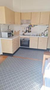 a kitchen with wooden cabinets and a stove at Löwenzahn in Scheibbs +10 photos