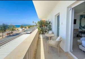 a balcony with a table and chairs and a view of the ocean at Ivory Dimora di Charme in Terracina