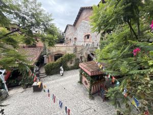 a courtyard of an old building with flags on it at Anae en ValQuirico in Santeagueda