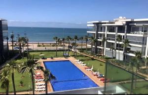 a view of the beach from the balcony of a resort at Les belles terrasses mansouria in Mansouria