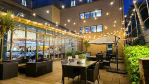 a restaurant with a table and chairs in front of a building at Holiday Inn Express Windsor by IHG in Windsor