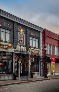 a building with signs on the side of a street at Heart & Hops Brewery Suites in Kingsville