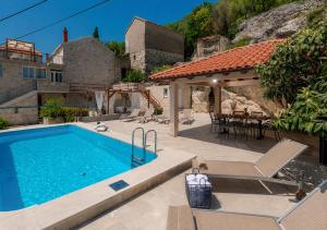 a house with a swimming pool and a patio at Villa Tea in Cavtat