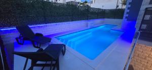 a lap pool with two chairs and a table and two chairs sidx sidx at Pool, Sauna, Jacuzzi with Sea view - Apartment Josipa in Podstrana