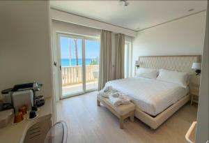 a bedroom with a bed and a view of the ocean at Ivory Dimora di Charme in Terracina