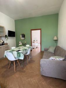 a living room with a table and a couch at Maison Veneto Vesuvius Rooftop in Torre Annunziata