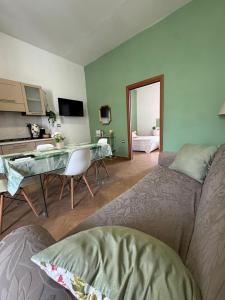 a bedroom with a bed and a table and a room at Maison Veneto Vesuvius Rooftop in Torre Annunziata +33 photos