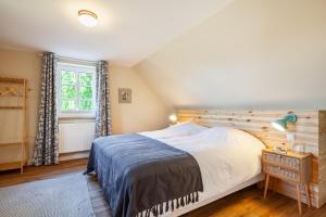 a bedroom with a large bed and a window at Kreuzkate-Ostholstein in Manhagen
