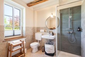 a bathroom with a shower and a toilet and a sink at Kreuzkate-Ostholstein in Manhagen +32 photos